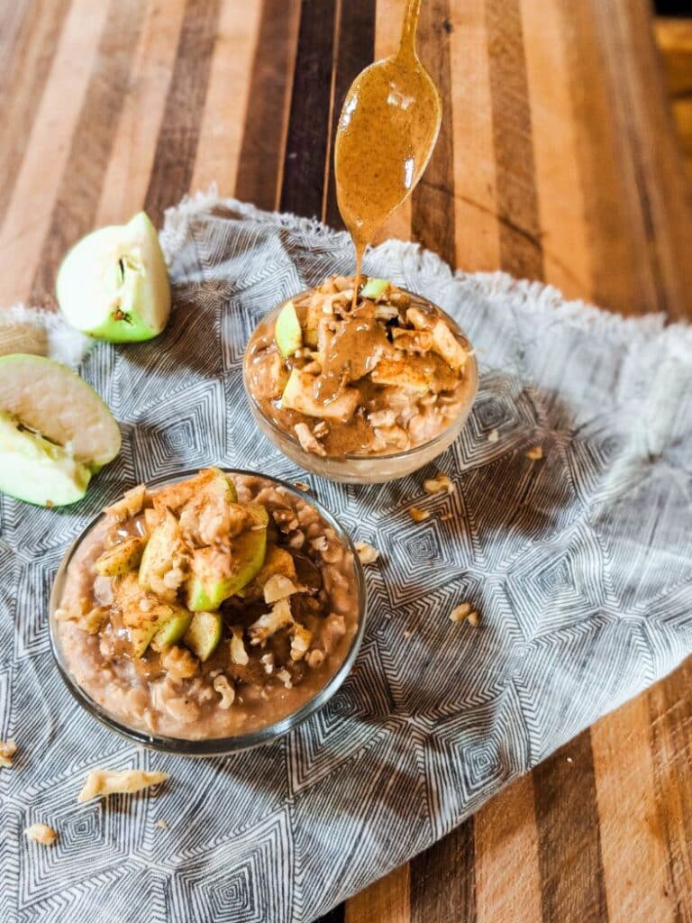 overhead image of overnight oats bowls drizzled with a spoonful of peanut butter