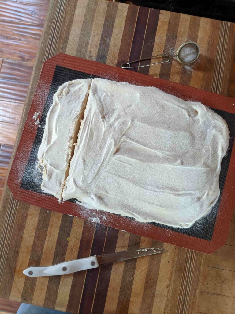 overhead image of homemade marshmallow dusted with powdered sugar and with one row sliced
