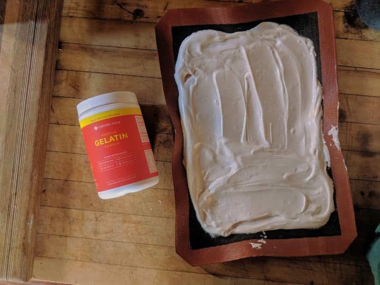 overhead image of homemade marshmallow cream next to a container of Further Food gelatin