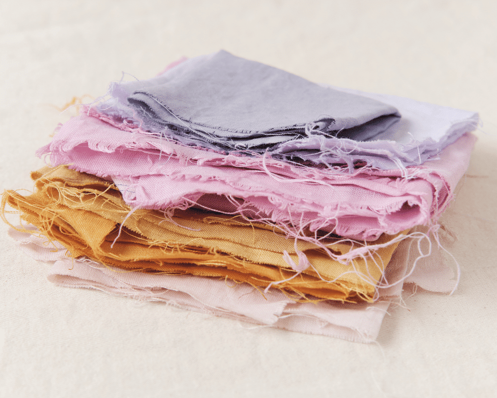 Image of a stack of various colored hemp material fabric