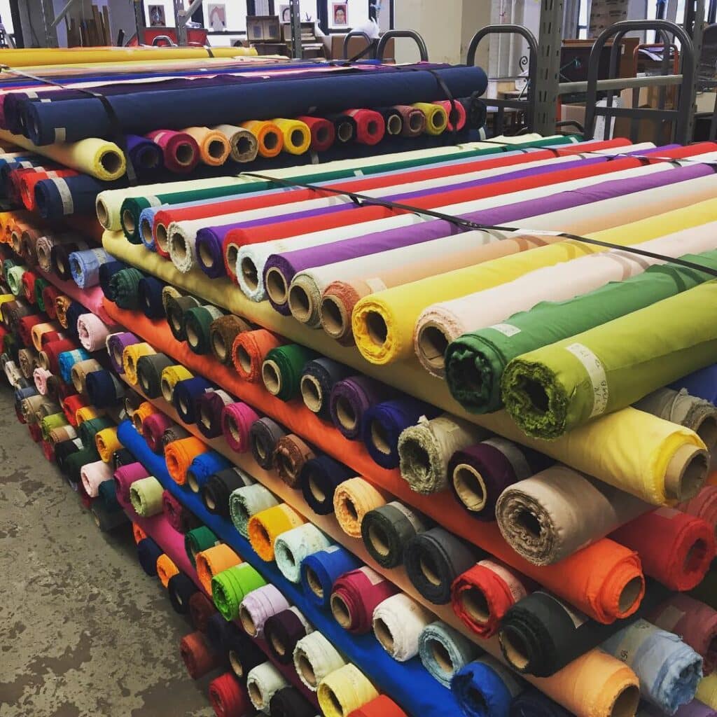 image of rolls of colored fabric in a creative reuse center