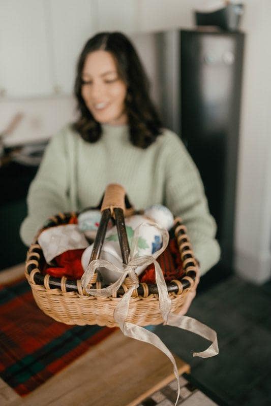 woman holding a basket with thrifty gifts inside