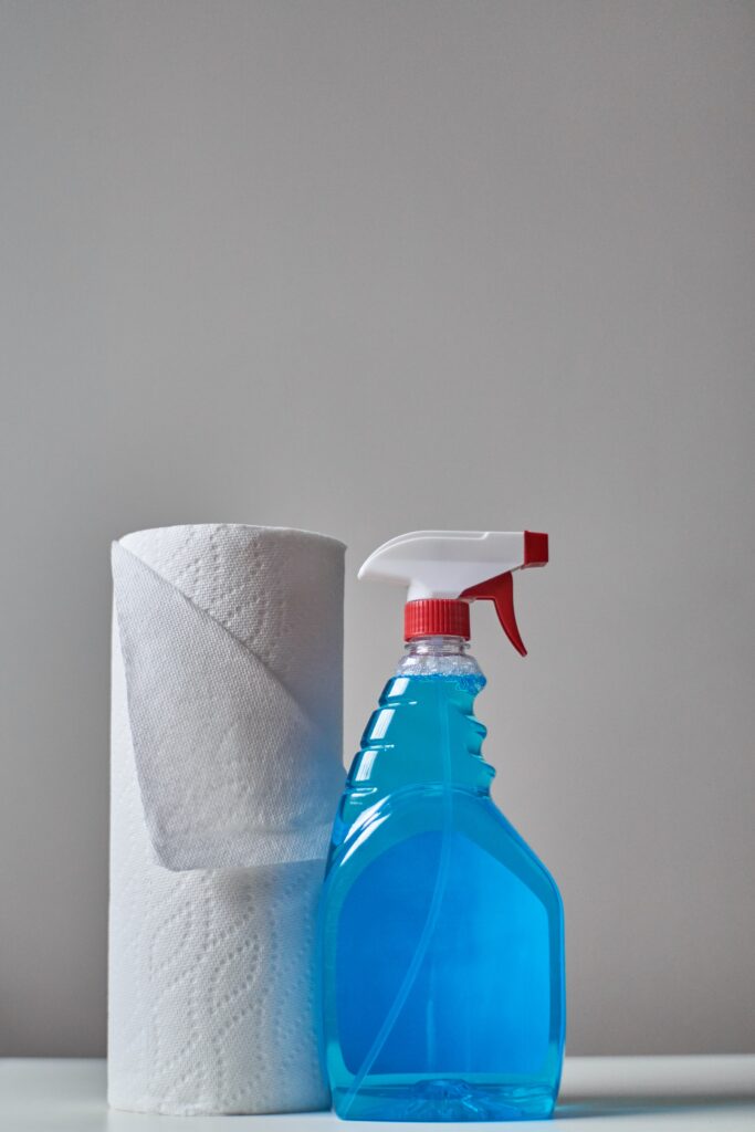 image of a roll of paper towels next to a bottle of cleaning spray