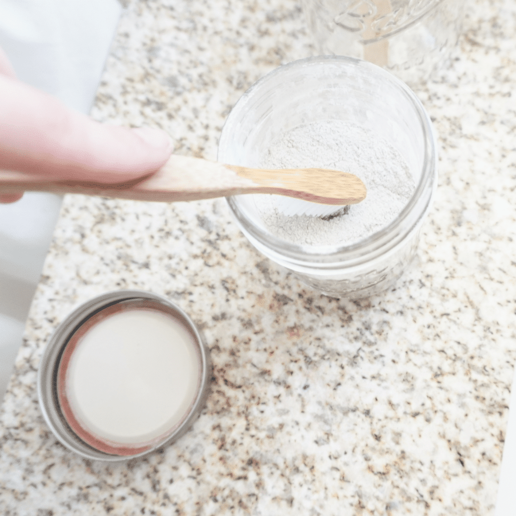 a tooth brush being dipped into a DIY tooth powder