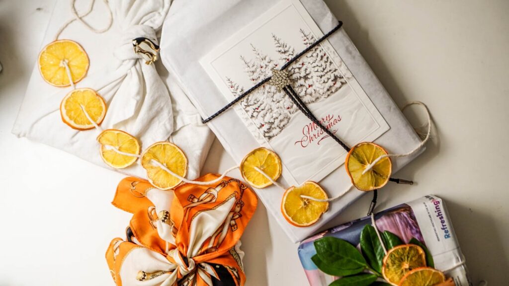 top view of sustainable gift wrapping options, including fabric, lariats, reused paper, and more.
