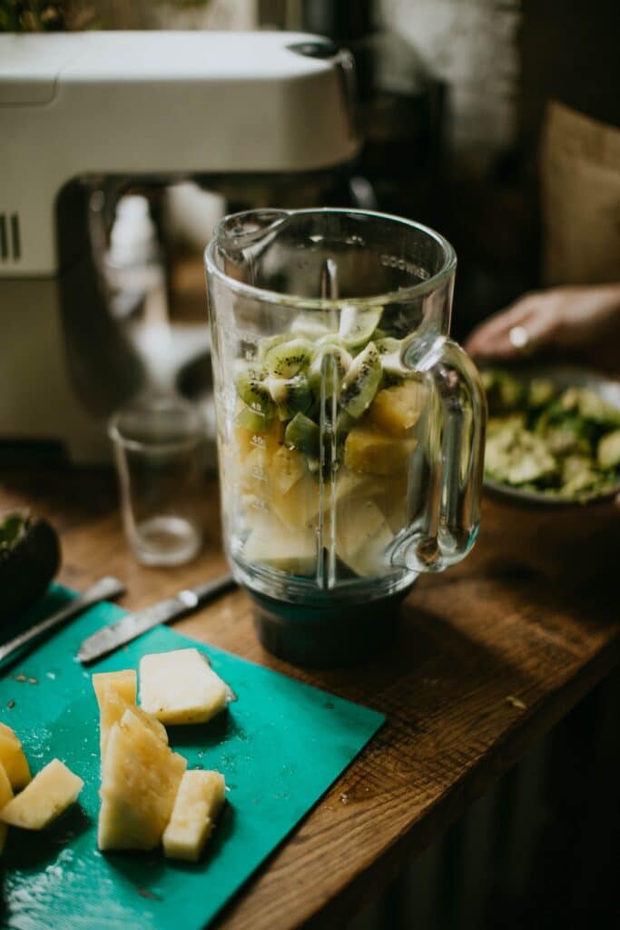 A photo of a blender filled with fruit - a staple of zero waste kitchen products.
