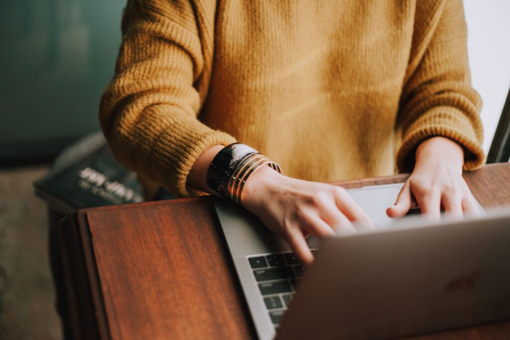 A woman sitting at a laptop to illustrate a post about jobs in environmental science